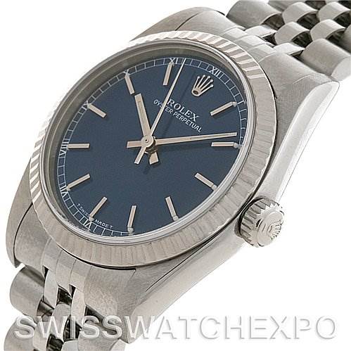 This is a close-up angle of a Rolex Mid-Size 77014 Women's Stainless Steel Blue Dial 77014 Women's Stainless Steel Blue Dial watch showing the face, bezel, crown, and part of the bracelet.