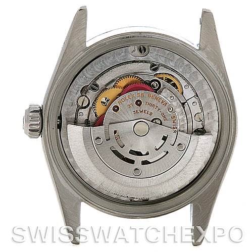 This image shows the rear view and inner movement of a Rolex Mid-Size 77080 Women's Stainless Steel Blue Dial 77080 Women's Stainless Steel Blue Dial watch, revealing its mechanical parts and rotor.