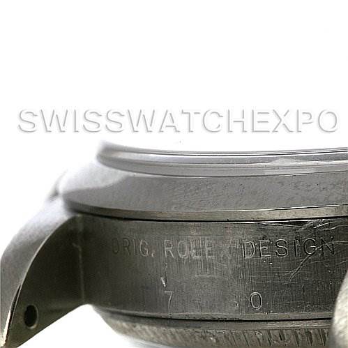The image shows a close-up side view of the case and bezel of a Mid-Size Rolex watch, highlighting the engraved text on the case side.