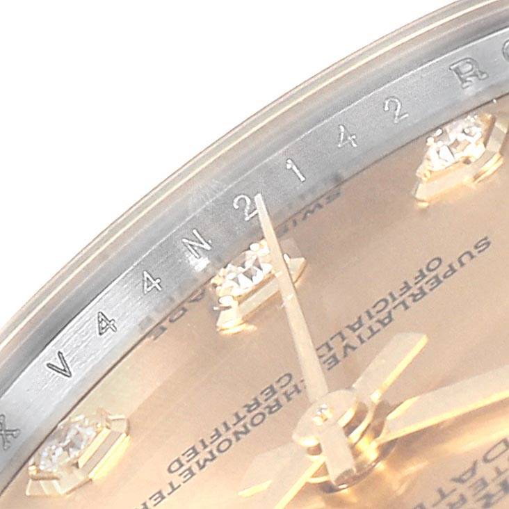 This is a close-up of the dial and bezel of a Mid-Size Rolex watch, showing the hands and diamond markers.