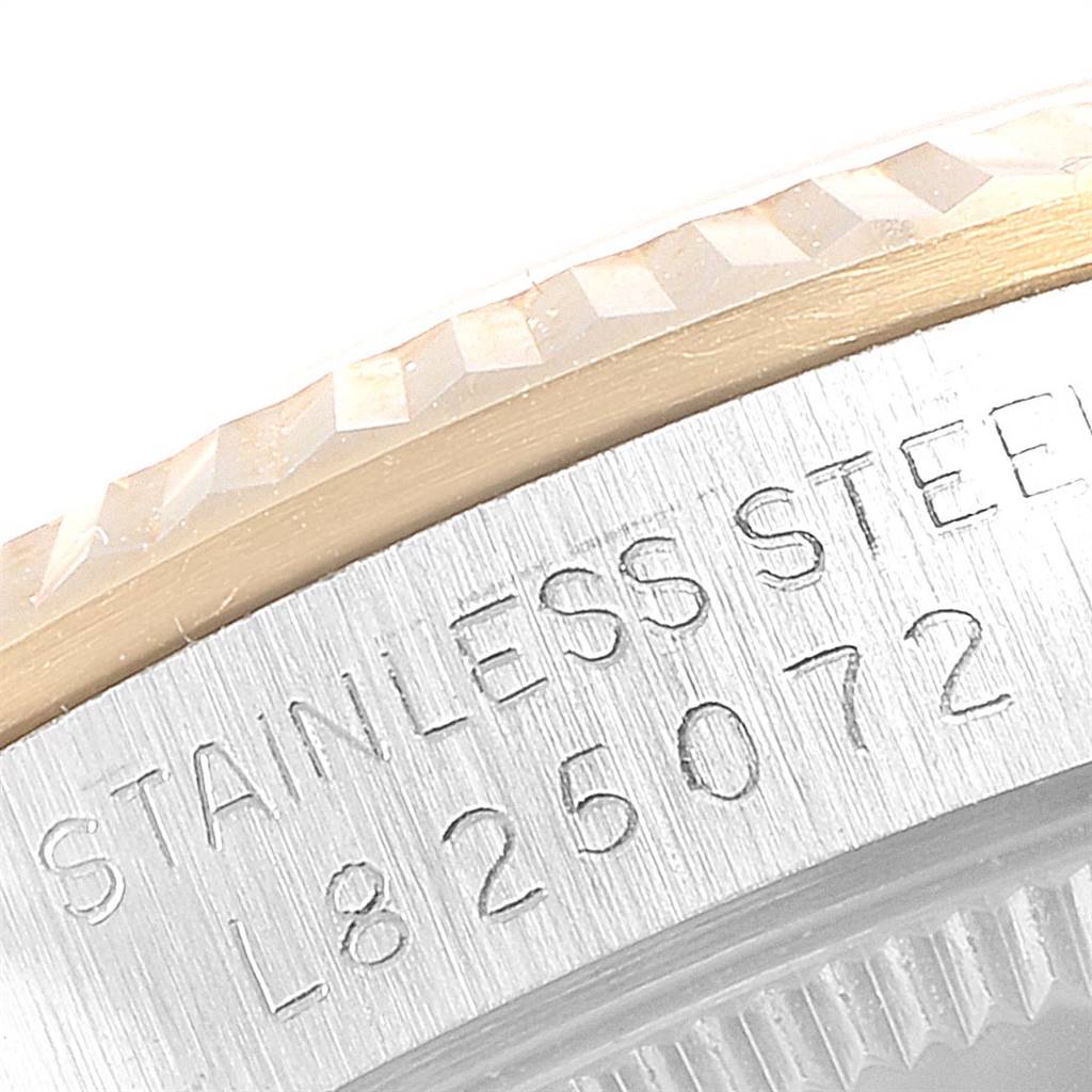 This image shows a close-up angle of the serial number and stainless steel engraved case edge of a Rolex Mid-Size 68273 Women's Steel and Gold (two tone) Black Dial 68273 Women's Steel and Gold (two tone) Black Dial model watch.