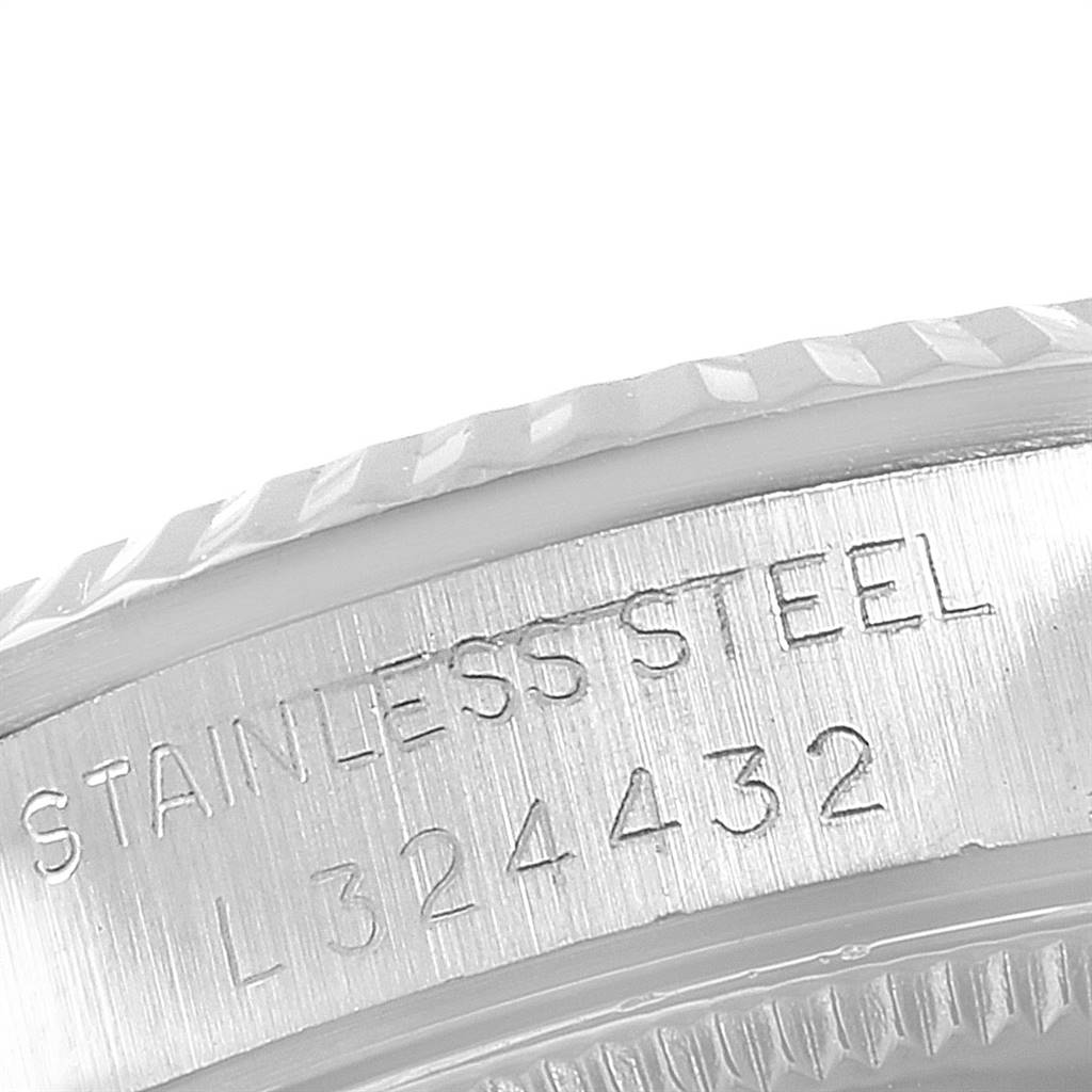 This is a close-up of the side of a Rolex Mid-Size 68274 Women's Stainless Steel Silver Dial 68274 Women's Stainless Steel Silver Dial model watch, showing the stainless steel engraving and part of the bezel.