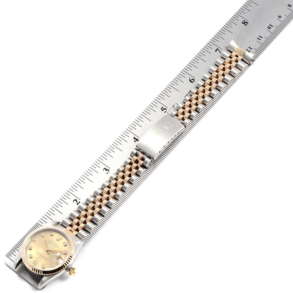 The image shows a Rolex Mid-Size 68273 Women's Steel and Gold (two tone) Champagne Dial 68273 Women's Steel and Gold (two tone) Champagne Dial watch laid flat beside a ruler, highlighting the bracelet and clasp.