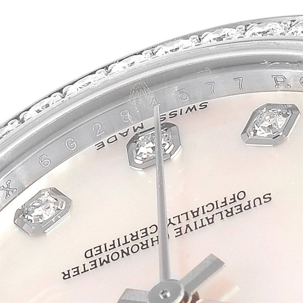 The image shows a close-up of the Rolex Mid-Size 178384 Women's Stainless Steel Mother of Pearl Dial 178384 Women's Stainless Steel Mother of Pearl Dial watch's dial, showcasing the second hand, diamond hour markers, and part of the bezel.