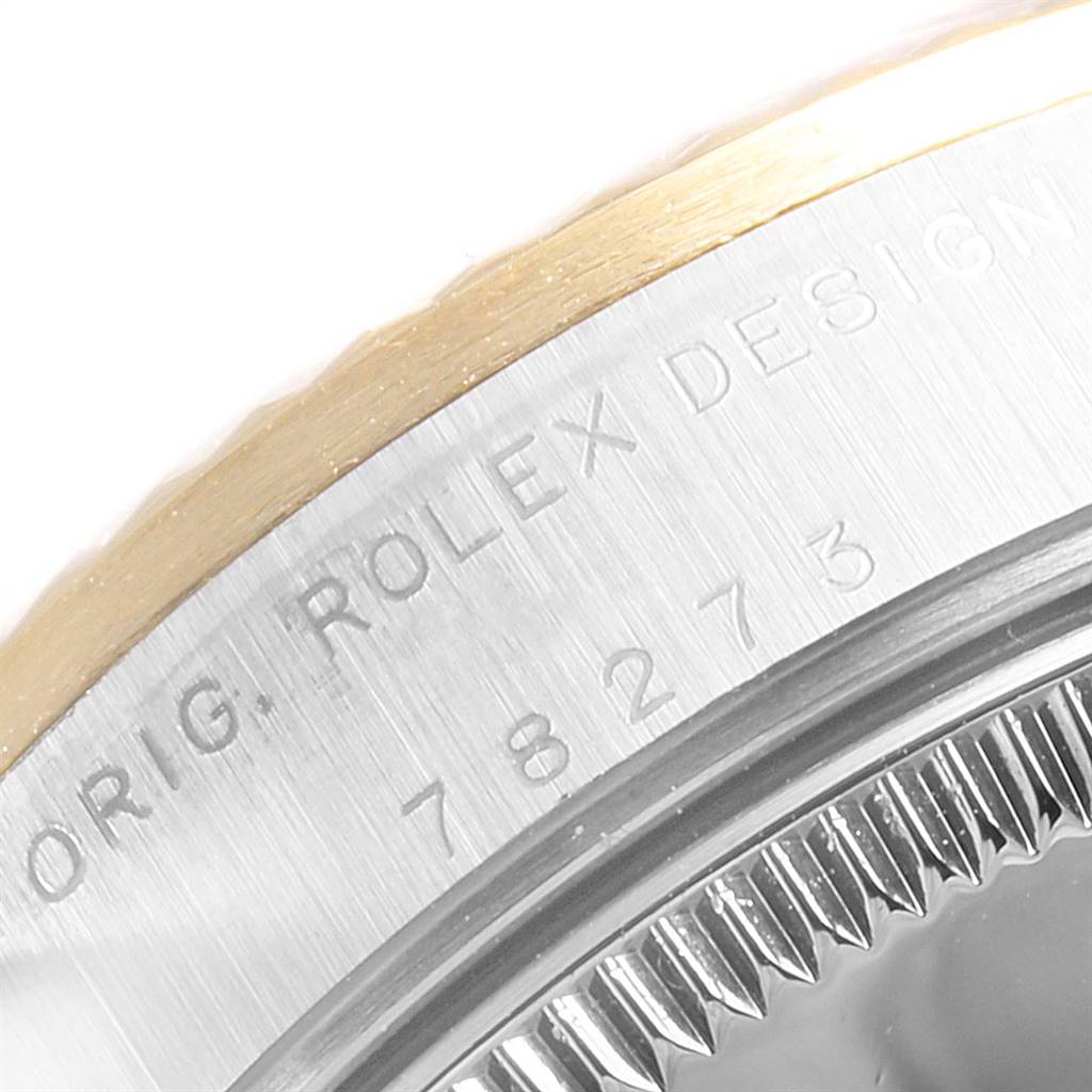 This image shows a close-up of the bezel and engraved model number of a Mid-Size Rolex watch.