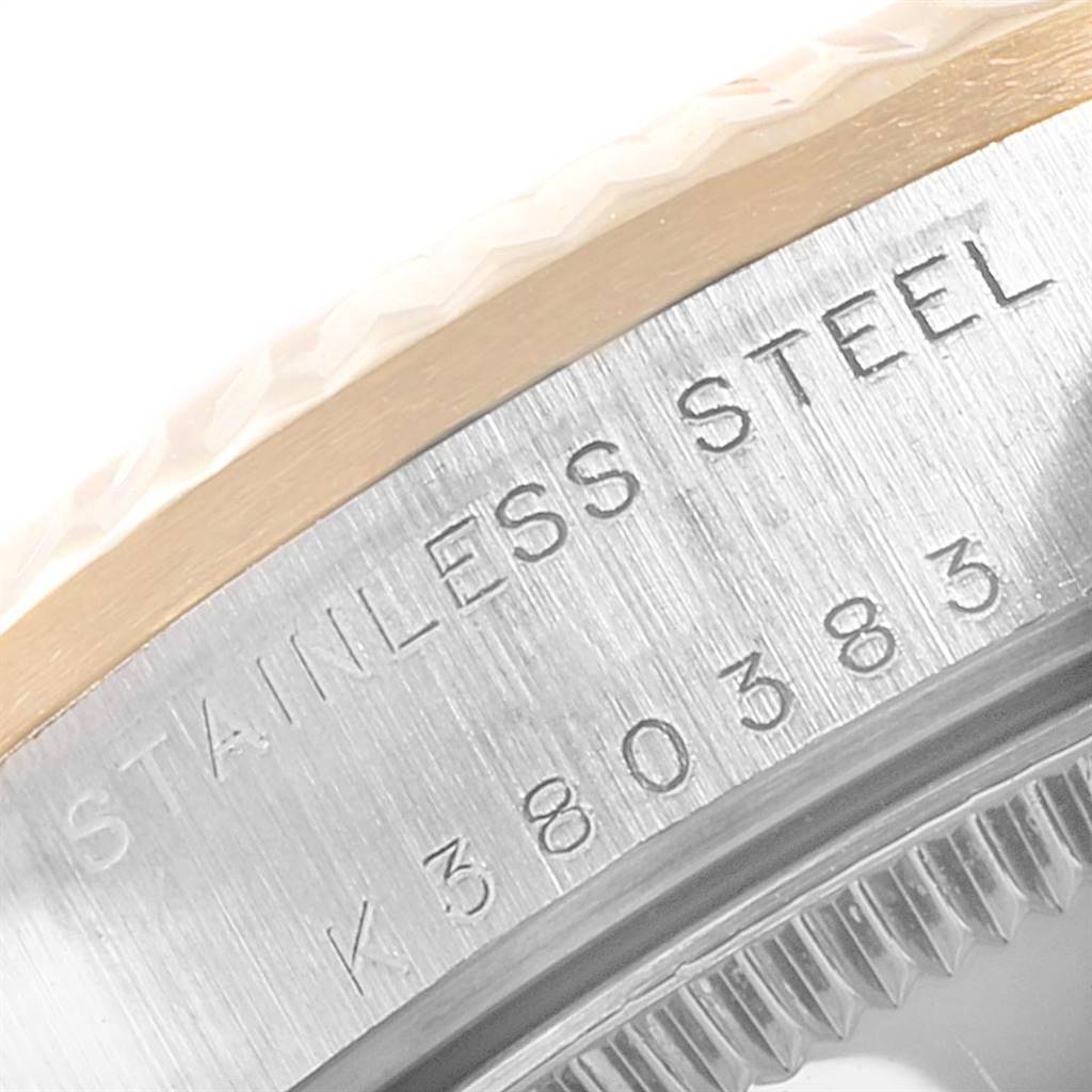 This image shows a close-up of the serial number and stainless steel marking on the bezel of a Rolex Mid-Size 78273 Women's Steel and Gold (two tone) Black Dial 78273 Women's Steel and Gold (two tone) Black Dial watch.
