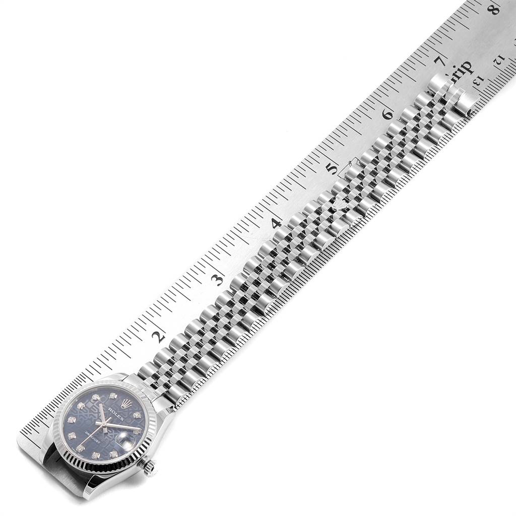 The image shows a side view of a Rolex Mid-Size 178274 Women's Stainless Steel Blue Dial 178274 Women's Stainless Steel Blue Dial watch placed next to a ruler for measurement, displaying the face and bracelet.