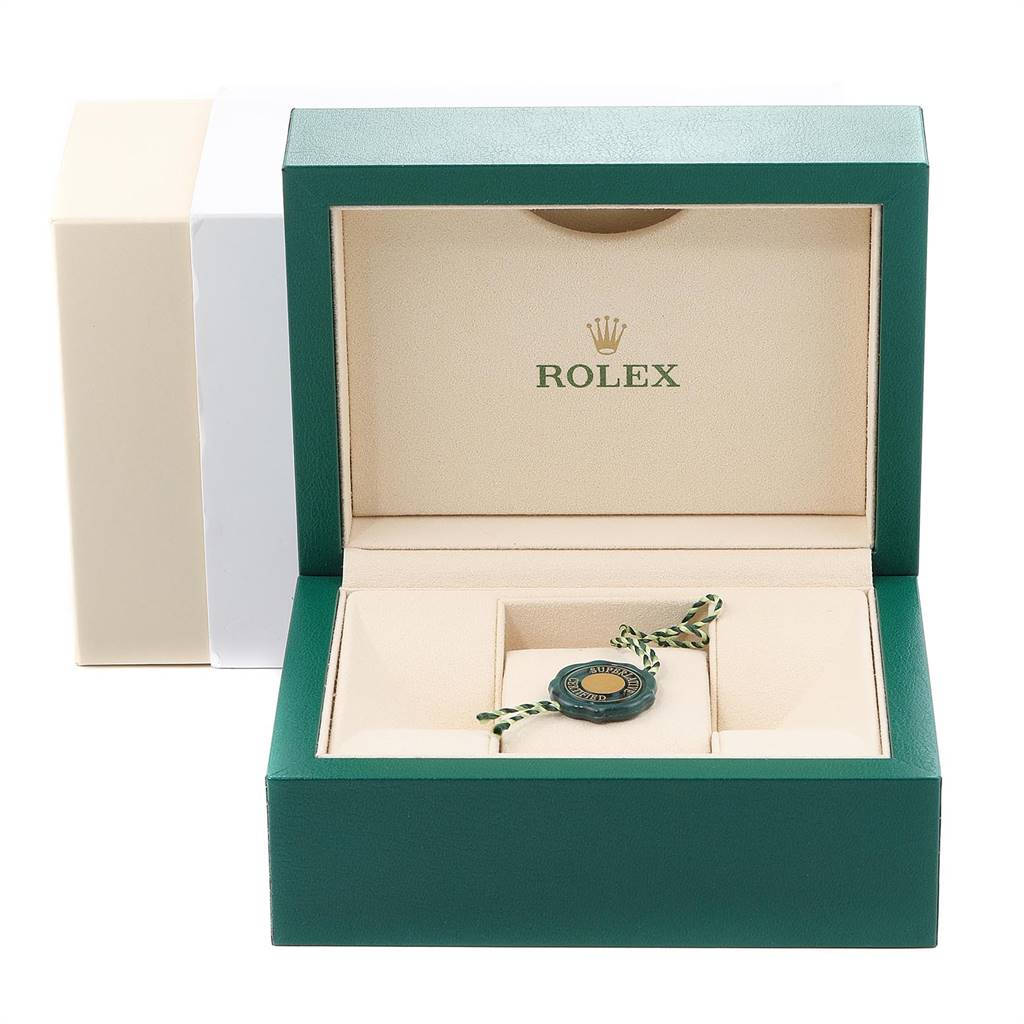 The image shows the open box of a Rolex Mid-Size 178384 Women's Stainless Steel Blue Dial 178384 Women's Stainless Steel Blue Dial model watch, displaying the interior compartments and a green tag accessory.