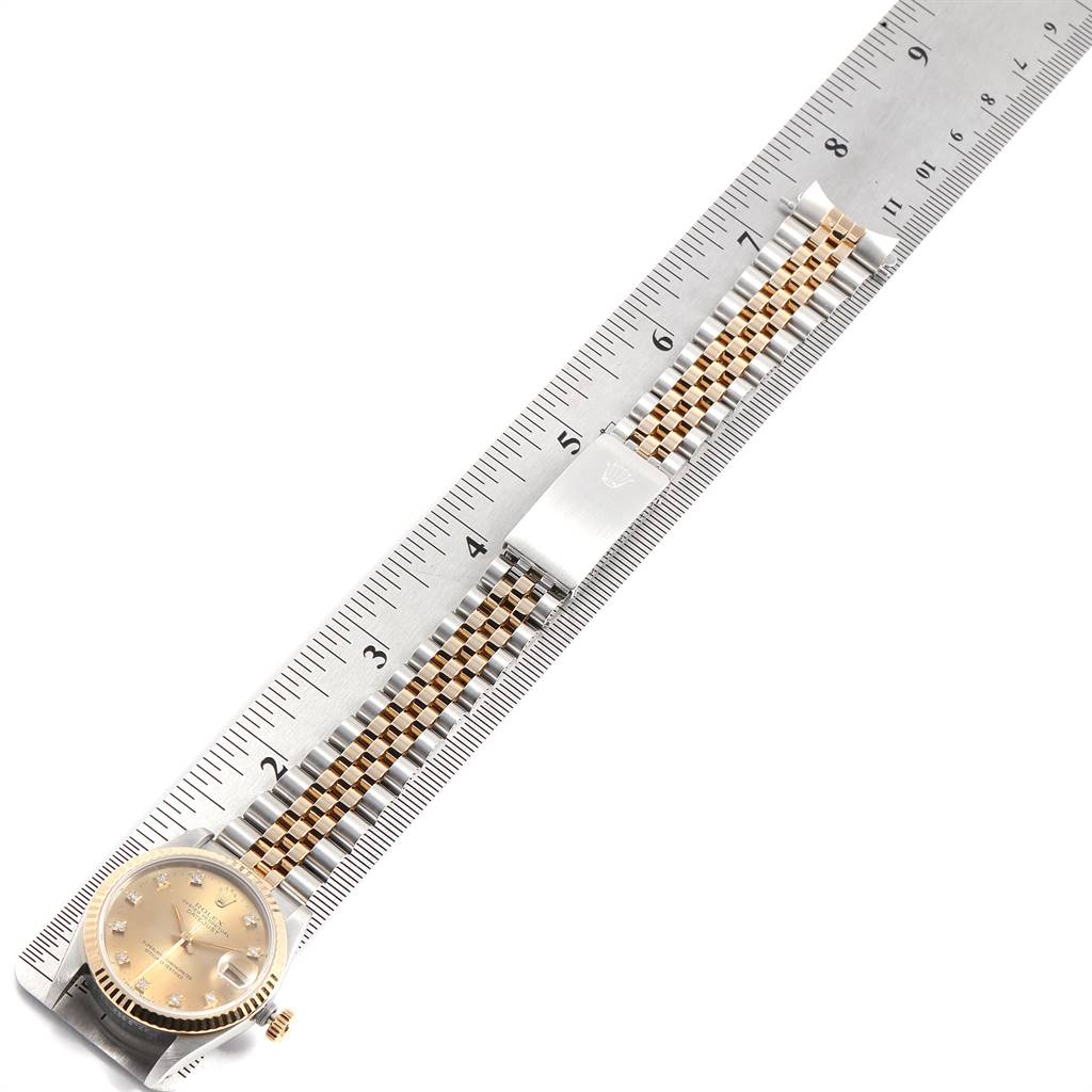 The Rolex Mid-Size 68273 Women's Steel and Gold (two tone) Champagne Dial 68273 Women's Steel and Gold (two tone) Champagne Dial watch is shown from a top-down angle, displaying the face, bezel, and entire two-tone bracelet, measured against a ruler.