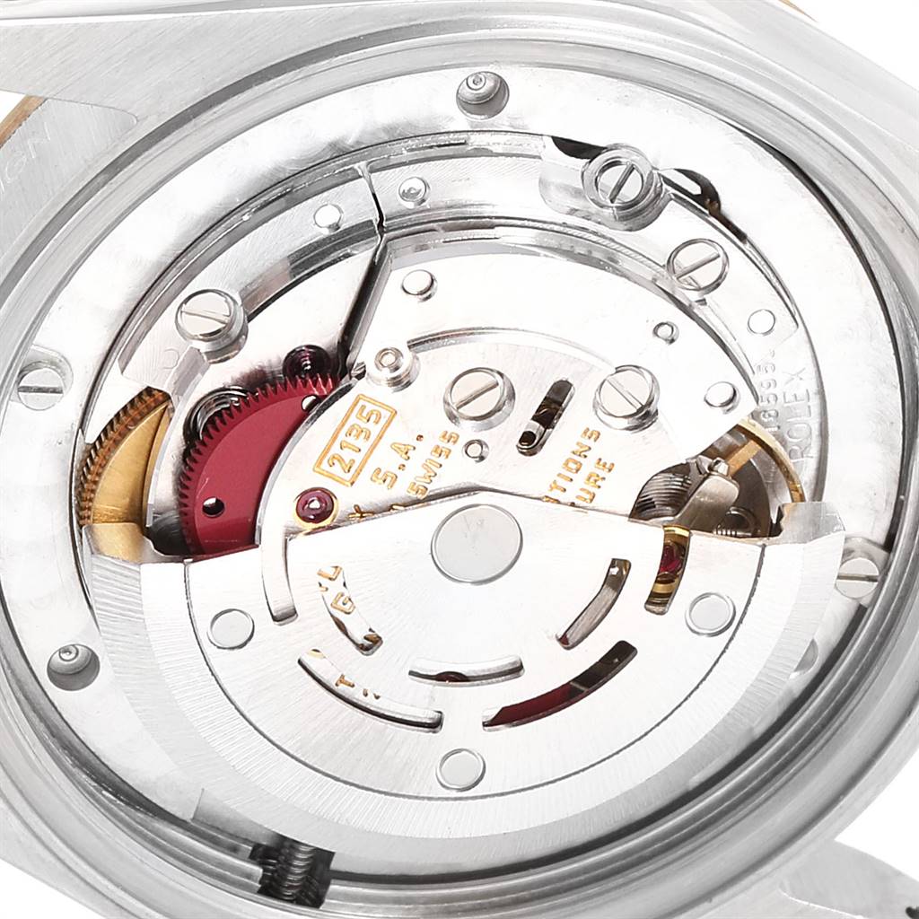 This image shows the internal movement mechanism of a Rolex Mid-Size 68273 Women's Steel and Gold (two tone) Champagne Dial 68273 Women's Steel and Gold (two tone) Champagne Dial watch, highlighting gears and intricate components from a close-up angle.