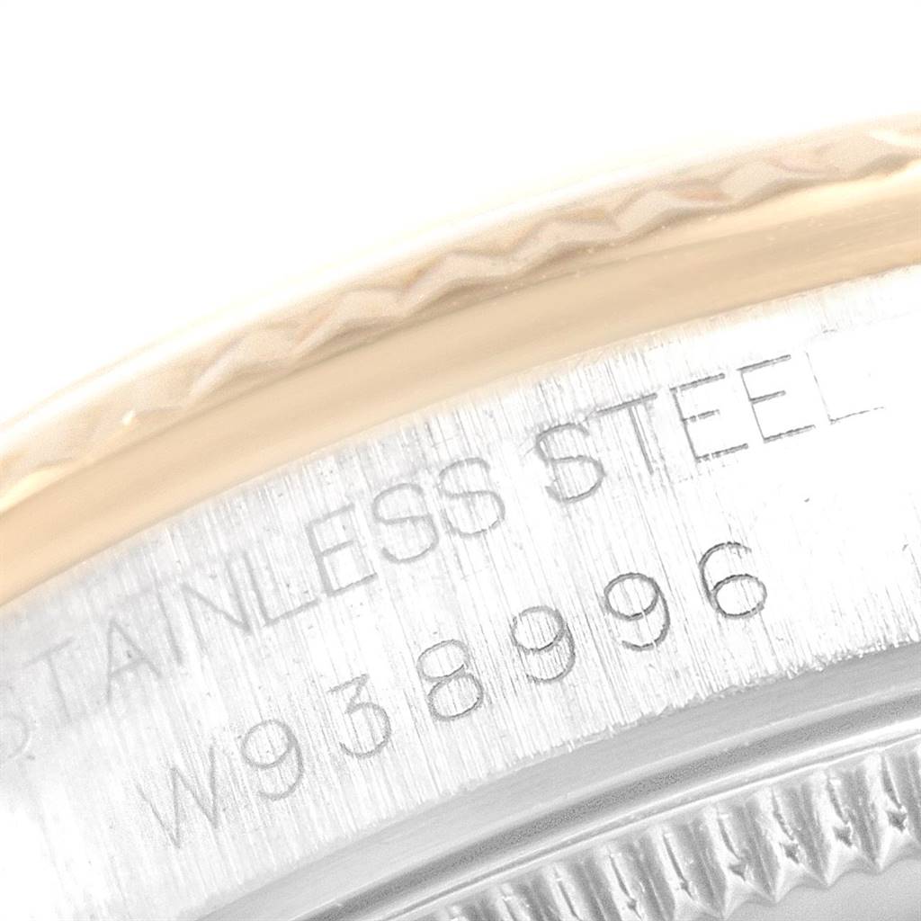 This close-up image shows part of the stainless steel case and engraved serial number of a Mid-Size Rolex watch.