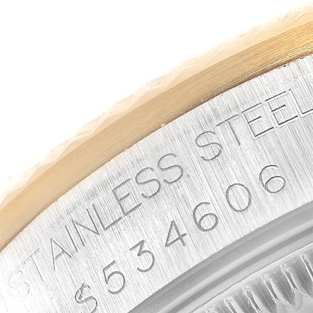 This close-up image shows the edge of the bezel and part of the casing with engraved text of a midsize Rolex watch.