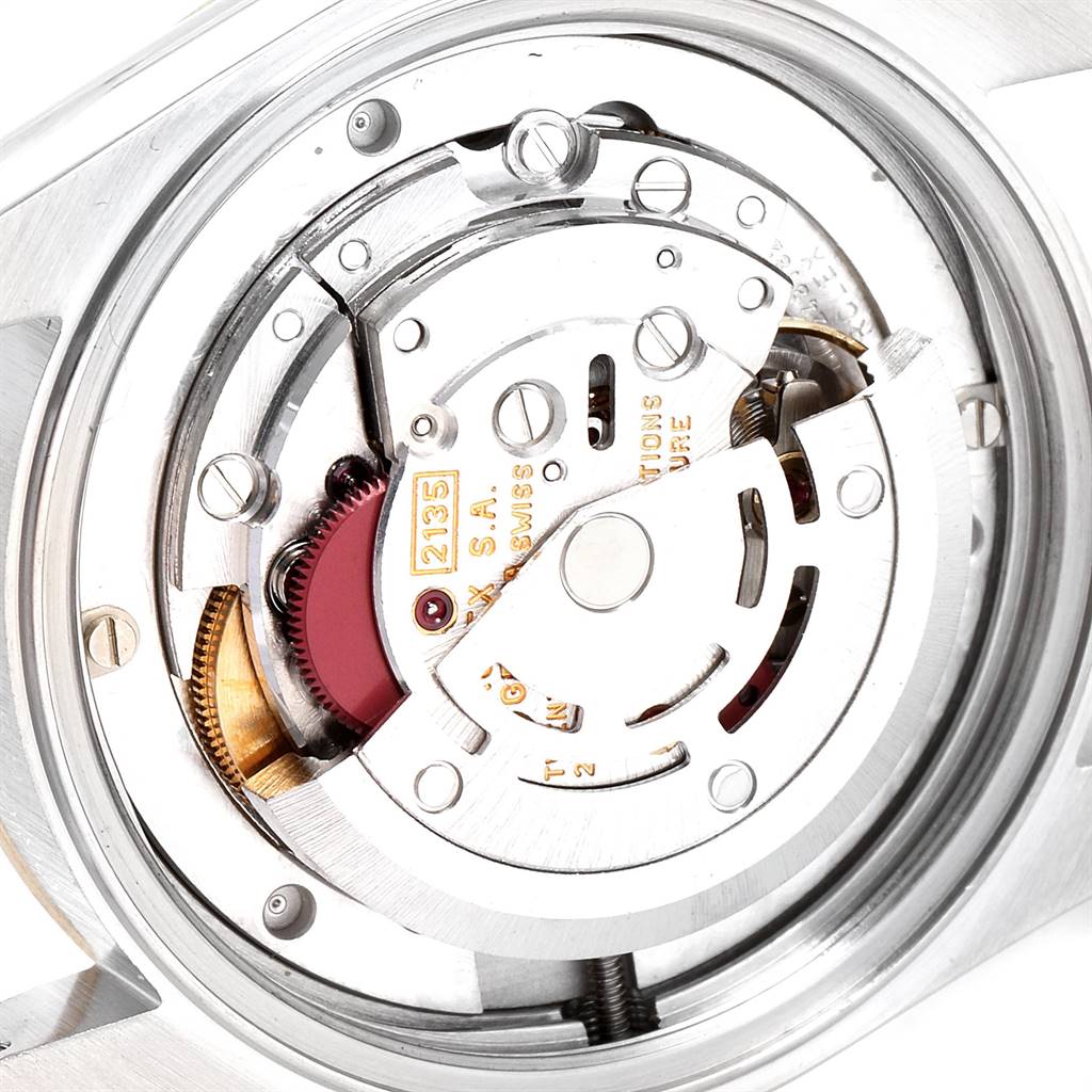 The image shows a close-up, rear view of the movement mechanism inside a Mid-Size Rolex watch.