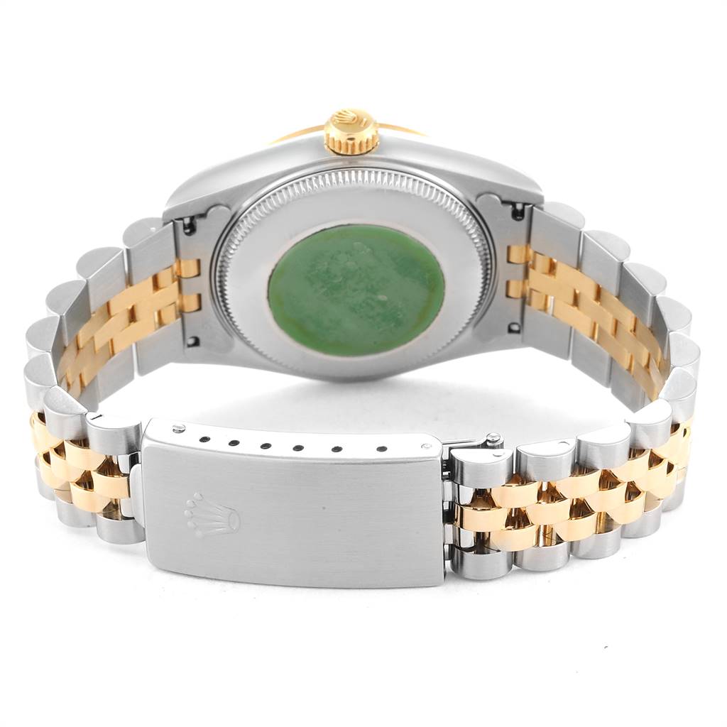 This image shows the backside and clasp of a Rolex Mid-Size 68273 Women's Steel and Gold (two tone) Beige Dial 68273 Women's Steel and Gold (two tone) Beige Dial watch with a two-tone metal bracelet.