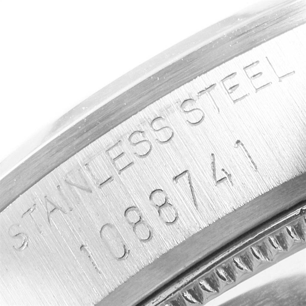 The image shows a close-up of the case side, revealing the serial number and "Stainless Steel" engraving on a Rolex Mid-Size 6466 Women's Stainless Steel Black Dial 6466 Women's Stainless Steel Black Dial model.