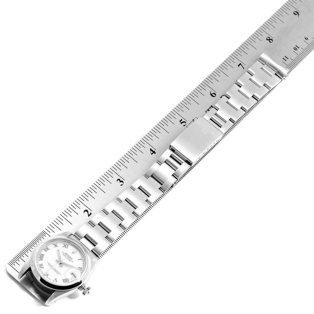 The image shows a Mid-Size Rolex watch with its bracelet and clasp measured against a ruler from a top-down angle.