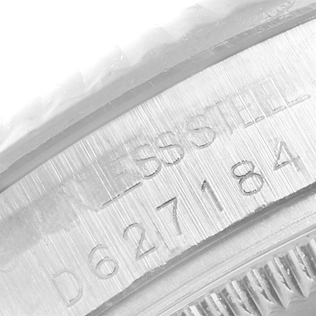 The image shows a close-up of the side of a Rolex Mid-Size 178274 Women's Stainless Steel Silver Dial 178274 Women's Stainless Steel Silver Dial model watch, highlighting the serial number and stainless steel engraving.