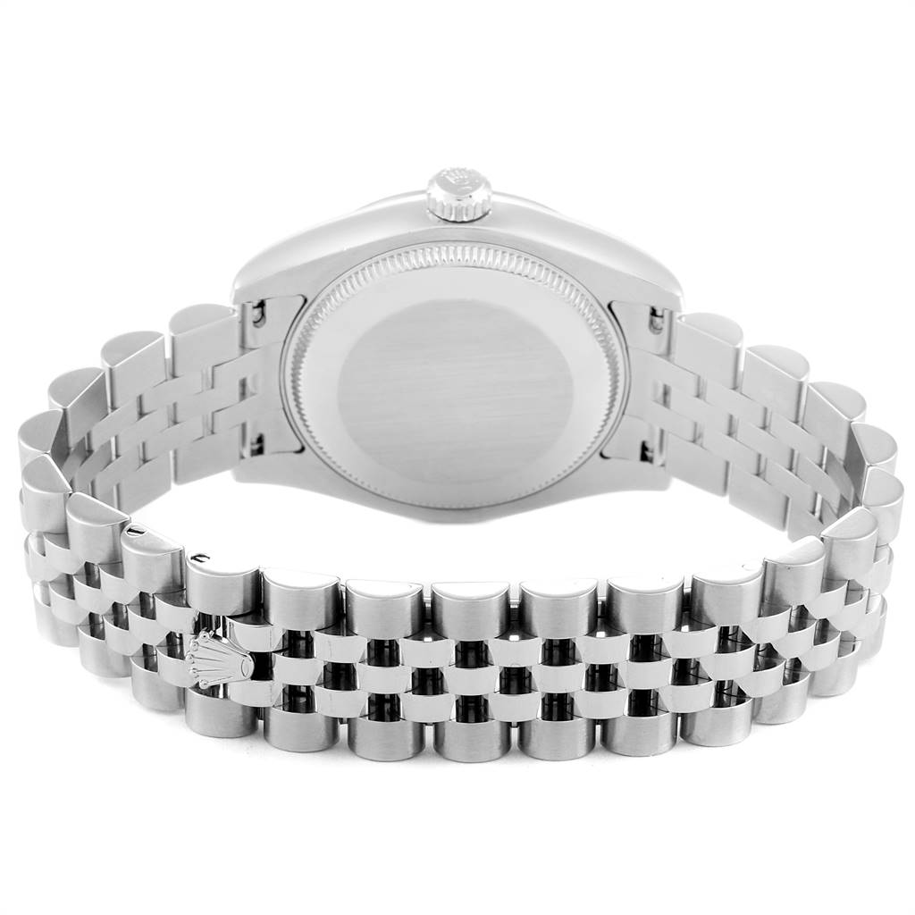 The image shows the back case and bracelet of a mid-size Rolex watch, taken from the rear angle.