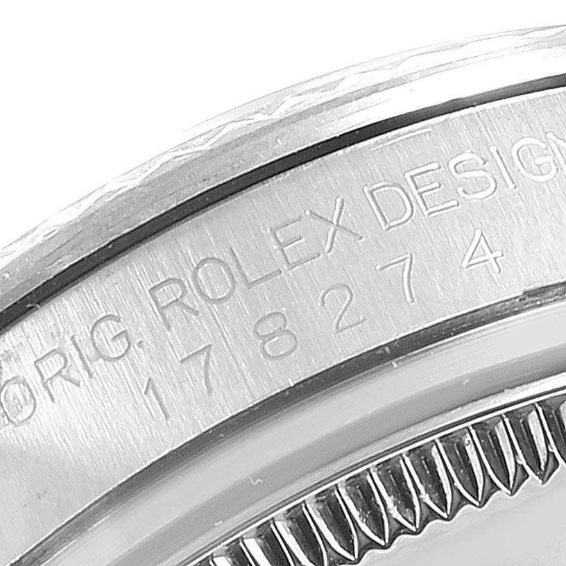 This close-up image shows the side engraving and fluted bezel of a Rolex Mid-Size 178274 Women's Stainless Steel Silver Dial 178274 Women's Stainless Steel Silver Dial model watch.