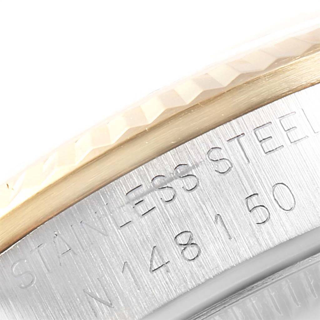 This close-up image shows the engraved stainless steel part of a Rolex Mid-Size 68273 Women's Steel and Gold (two tone) Champagne Dial 68273 Women's Steel and Gold (two tone) Champagne Dial watch case near the bezel.