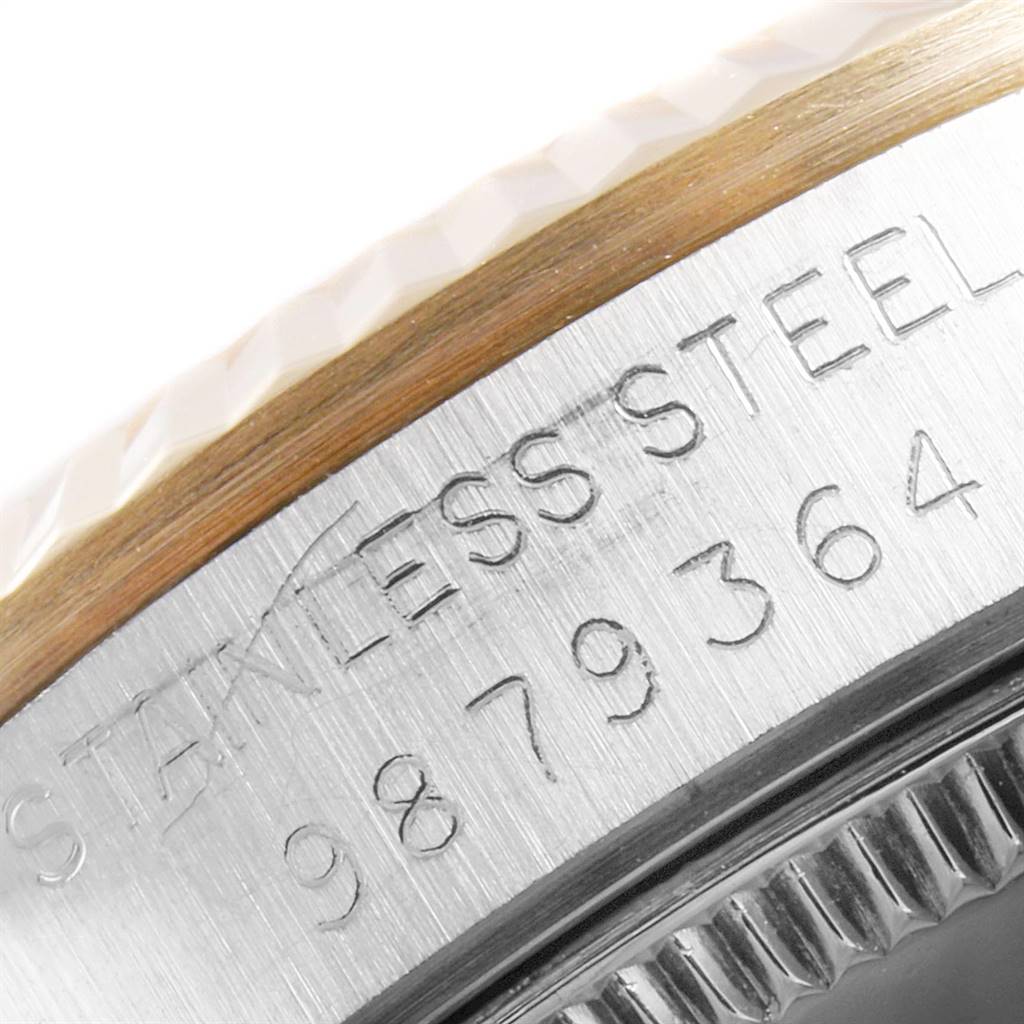 This close-up image shows the serial number and stainless steel inscription on the side of a Rolex Mid-Size 68273 Women's Steel and Gold (two tone) Champagne Dial 68273 Women's Steel and Gold (two tone) Champagne Dial watch case.