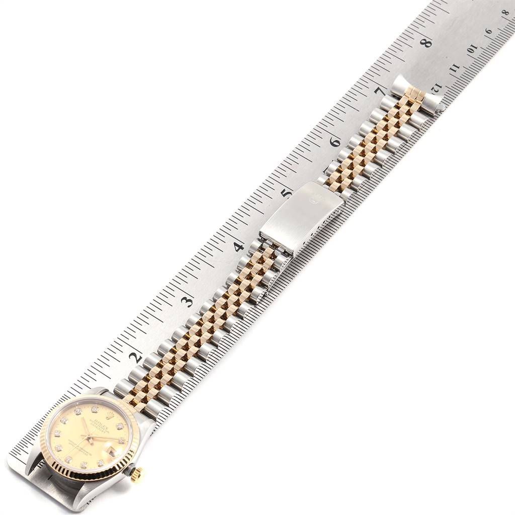 The image shows a Rolex Mid-Size 68273 Women's Steel and Gold (two tone) Champagne Dial 68273 Women's Steel and Gold (two tone) Champagne Dial watch face and bracelet laid next to a ruler for measurement, viewed from above.