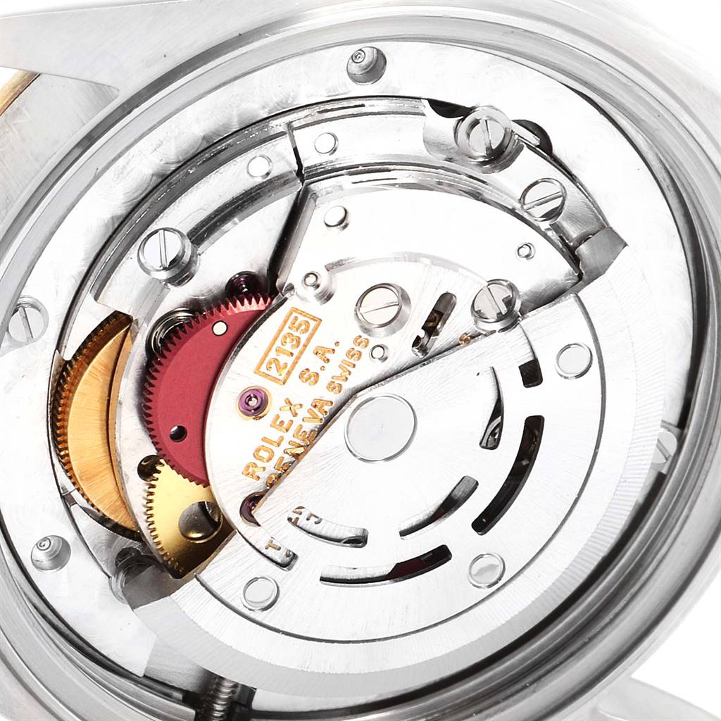The image shows the internal movement mechanism of a Mid-Size Rolex watch at a close-up angle.