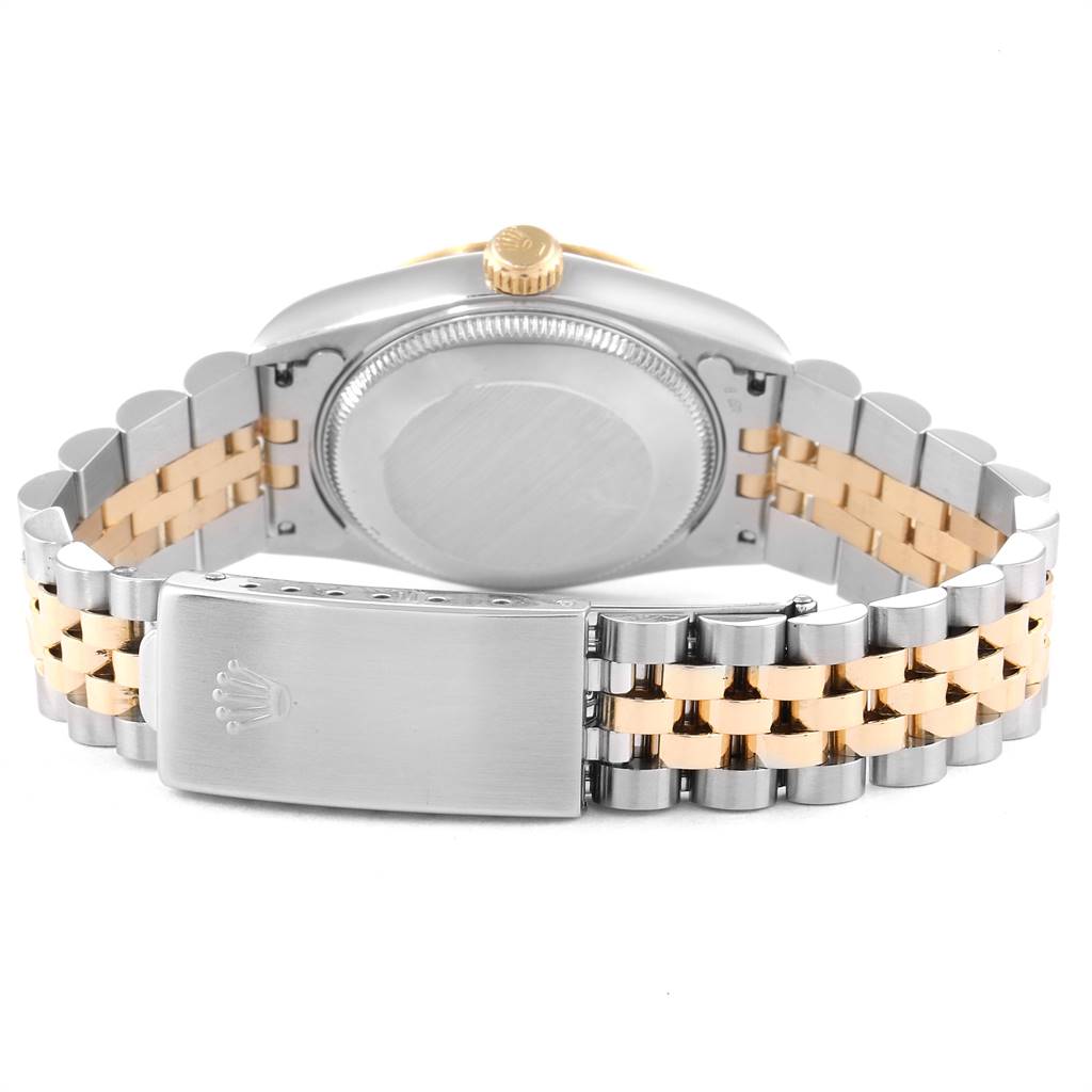 The Rolex Mid-Size 68273 Women's Steel and Gold (two tone) Champagne Dial 68273 Women's Steel and Gold (two tone) Champagne Dial watch is shown from the back, highlighting the case, crown, and two-tone metal bracelet with clasp.