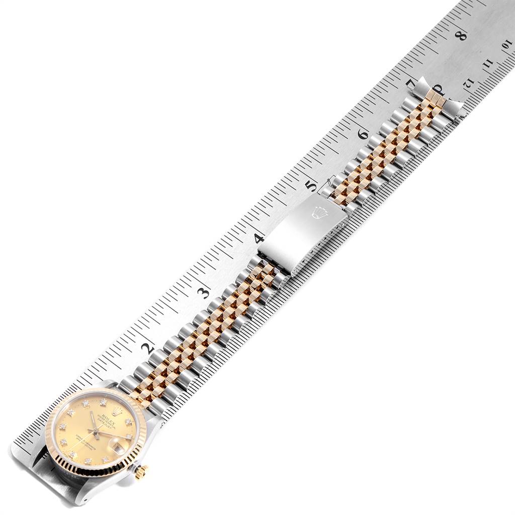 The image shows a Rolex Mid-Size 68273 Women's Steel and Gold (two tone) Champagne Dial 68273 Women's Steel and Gold (two tone) Champagne Dial model watch laid flat against a ruler, displaying the entire face and bracelet.