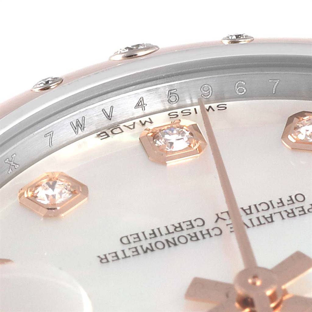 This close-up shows the Rolex Mid-Size 178341 Women
s Steel and Gold (two tone) Mother of Pearl Dial 178341 Women
s Steel and Gold (two tone) Mother of Pearl Dial watch face, highlighting the serial number, dial, diamonds, and part of the second hand.