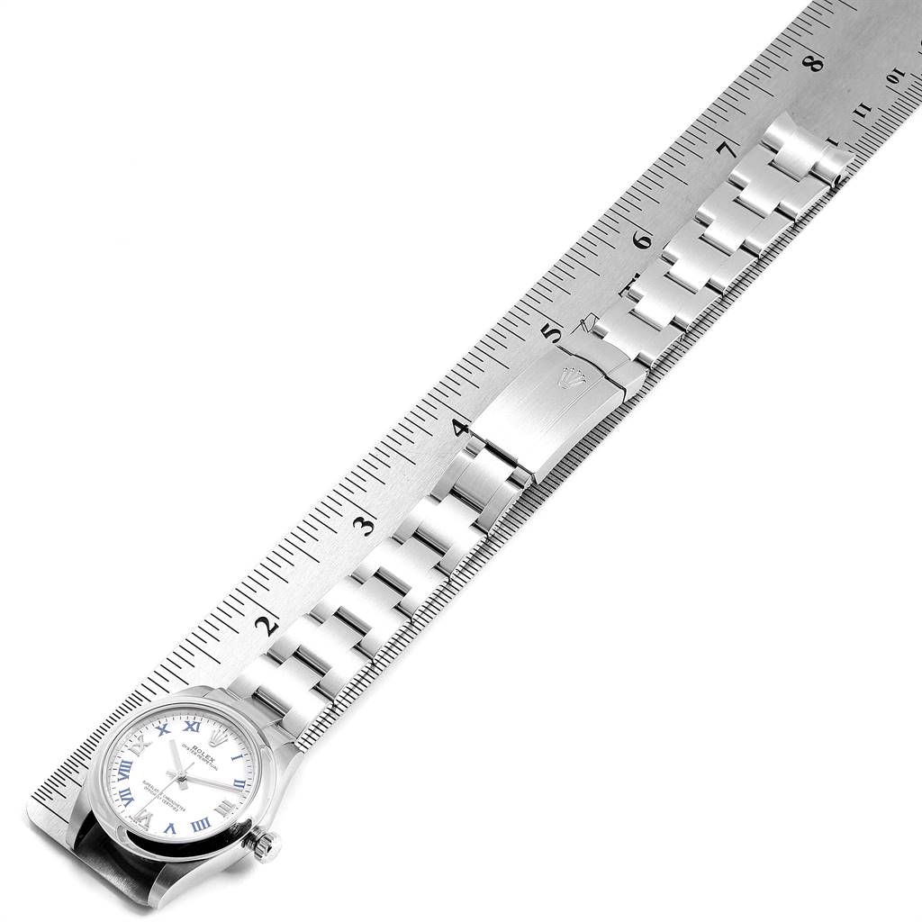 The image shows a top-down view of a Rolex Mid-Size 177200 Women's Stainless Steel White Dial 177200 Women's Stainless Steel White Dial watch, focusing on its bracelet and face, with a ruler for scale.