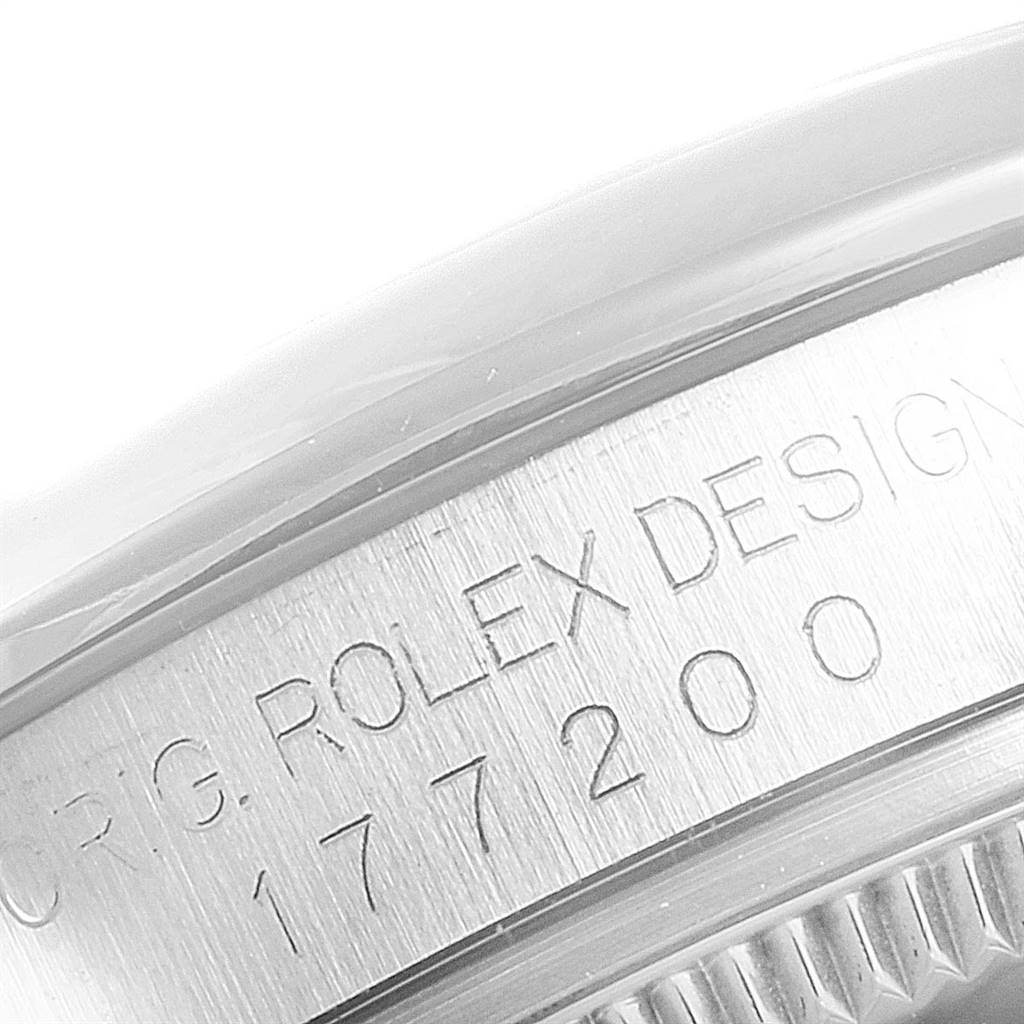 The image shows a close-up of the side of a Rolex Mid-Size 177200 Women's Stainless Steel White Dial 177200 Women's Stainless Steel White Dial watch case with engraved serial number and "Rolex Design."