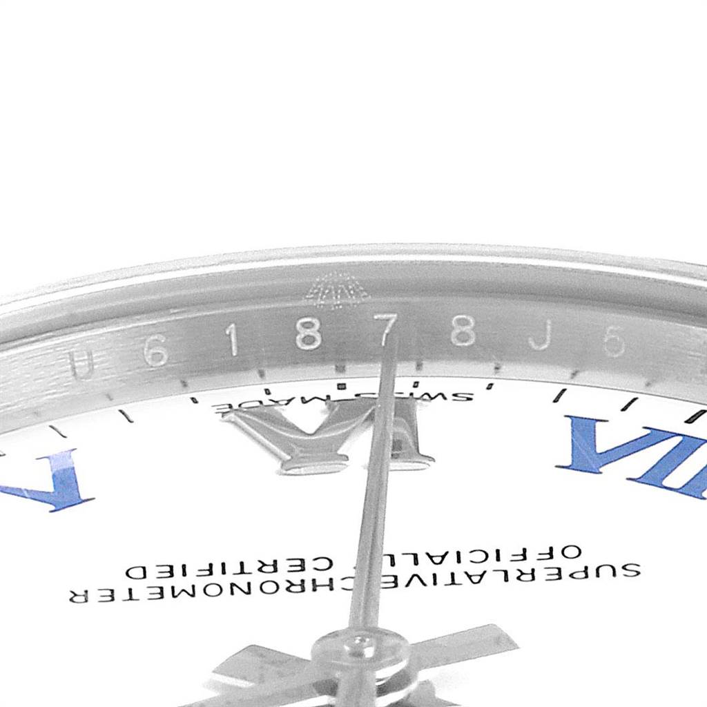 The image shows a close-up of the dial, hour and minute hands, and part of the chapter ring of a Mid-Size Rolex watch.
