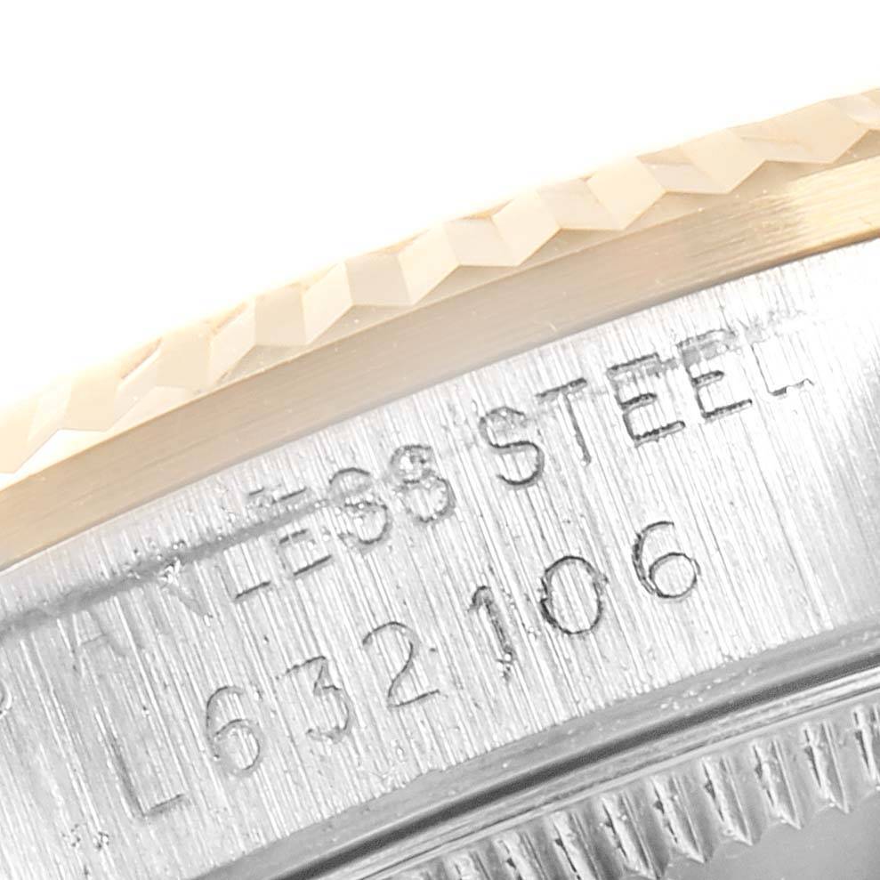 This close-up image shows the engraved stainless steel case with a partial view of the bezel on a Rolex Mid-Size 68273 Women's Steel and Gold (two tone) Beige Dial 68273 Women's Steel and Gold (two tone) Beige Dial model watch.