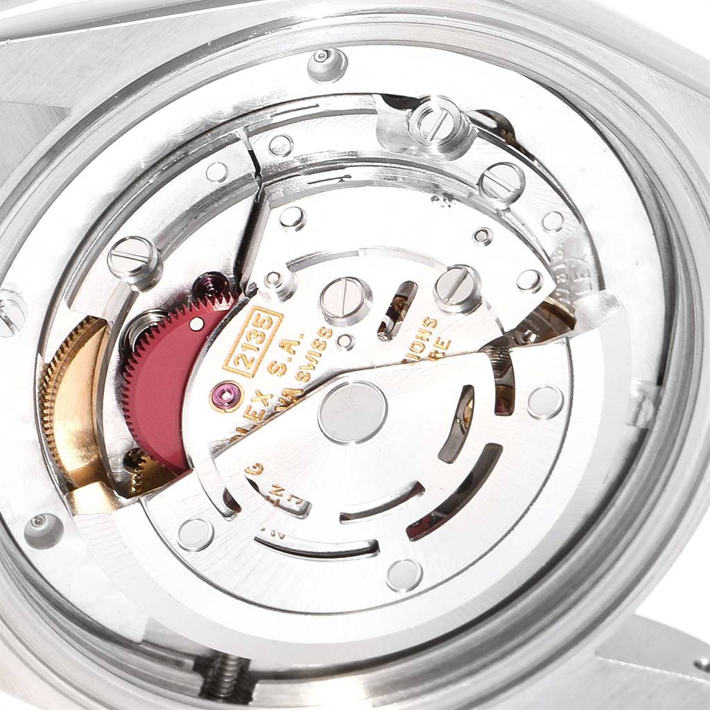 The image shows the internal mechanism of a Rolex Mid-Size 68273 Women's Steel and Gold (two tone) Champagne Dial 68273 Women's Steel and Gold (two tone) Champagne Dial model watch from a close-up angle, highlighting gears and components.