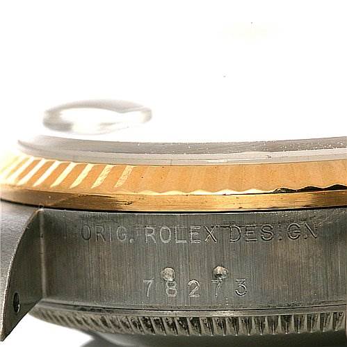 This image shows a close-up side view of a Mid-Size Rolex watch with visible engravings on the watch case and the bezel.