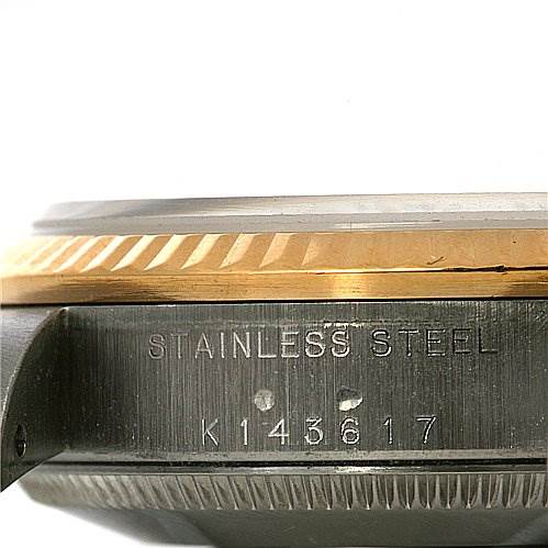 This image shows a close-up angle of the side of a Mid-Size Rolex watch case, highlighting the stainless steel material and model number.