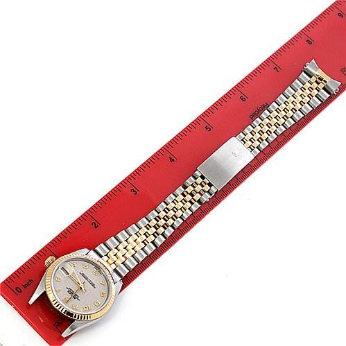 The image shows a Rolex Mid-Size 78273 Women's Stainless Steel Beige Dial 78273 Women's Stainless Steel Beige Dial watch from an overhead angle, displaying its face, bezel, and two-tone bracelet alongside a red ruler.