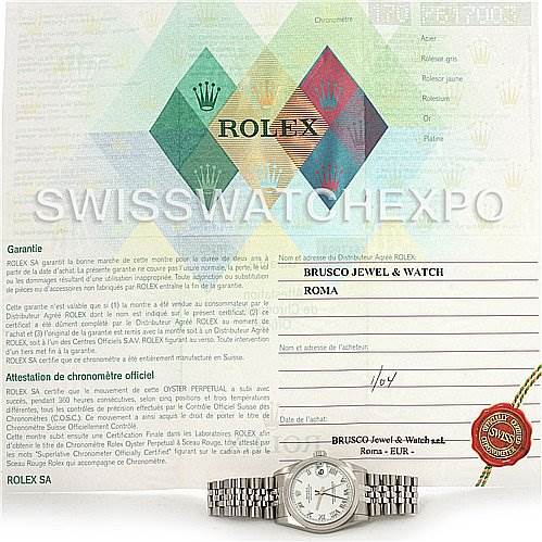 The image shows a Rolex Mid-Size 78240 Women's Stainless Steel White Dial 78240 Women's Stainless Steel White Dial watch positioned in front of its certificate of authenticity and warranty from Rolex.