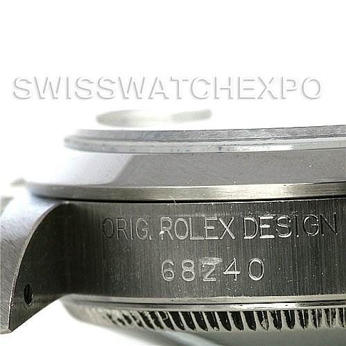 This image shows a close-up of a Rolex Mid-Size 68240 Women's Stainless Steel Pink Dial 68240 Women's Stainless Steel Pink Dial watch case edge, featuring the words "ORIG. ROLEX DESIGN" and a reference number.