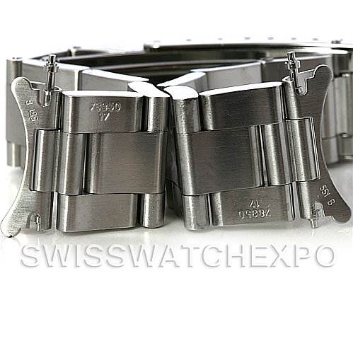 The image shows the bracelet and clasp of a Mid-Size Rolex watch, viewed from up close and showcasing the metal links and engravings.