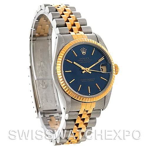 The image shows a Rolex Mid-Size 68273 Women
s Stainless Steel Blue Dial 68273 Women
s Stainless Steel Blue Dial watch at an angle showcasing its two-tone bracelet, blue dial, and gold bezel.