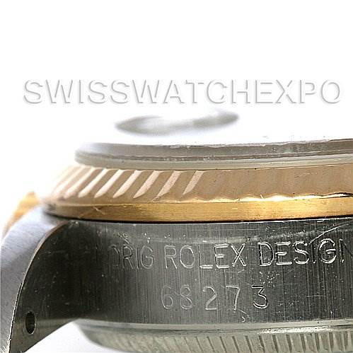 The image shows a close-up angle of the side of a Rolex Mid-Size 68273 Women
s Stainless Steel Blue Dial 68273 Women
s Stainless Steel Blue Dial watch, highlighting the engravings and part of the bezel.