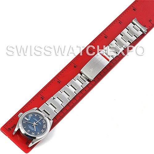 This image shows a Rolex Mid-Size 78240 Women's Stainless Steel Blue Dial 78240 Women's Stainless Steel Blue Dial watch laid flat, displaying the face, bracelet, and clasp against a red ruler.