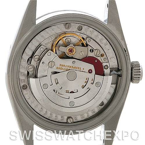 The image shows the open back view of a Rolex Mid-Size 68240 Women's Stainless Steel Silver Dial 68240 Women's Stainless Steel Silver Dial watch, revealing the internal movement and mechanics.