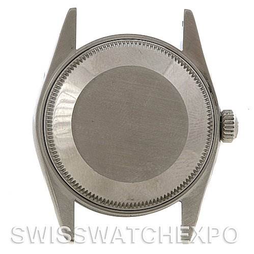 The image shows the case back and crown of a mid-size Rolex watch from a straight-on angle.
