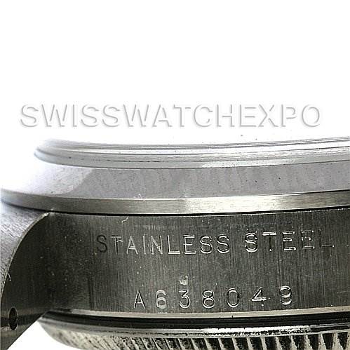 The image shows a close-up side view of the serial number and "Stainless Steel" engraving on a mid-size Rolex watch case.