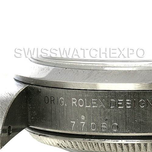 The image shows a side angle of a Rolex Mid-Size 77080 Women's Stainless Steel Black Dial 77080 Women's Stainless Steel Black Dial watch, focusing on the engraved case with the design number 77080.