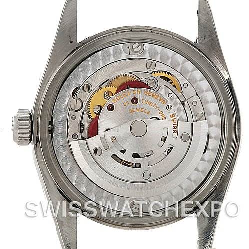 This image shows the open case back of a Rolex Mid-Size 77080 Women's Stainless Steel Black Dial 77080 Women's Stainless Steel Black Dial model, revealing the internal movement and intricate gears.