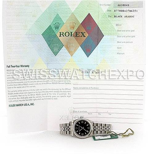 The image shows a Rolex Mid-Size 77080 Women's Stainless Steel Black Dial 77080 Women's Stainless Steel Black Dial watch laying flat on its bracelet, accompanied by its warranty card and tags in the background.